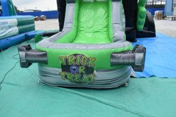 Slide exit of the Little Frankie Halloween combo bounce house with Trick or Treat graphic