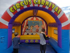 Circus carnival themed bounce house setup for a Halloween backyard party